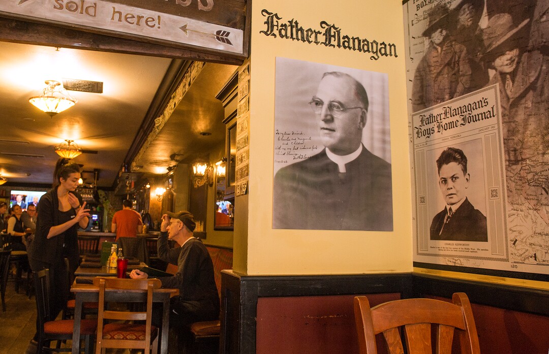 Leah Hogsten  |  The Salt Lake Tribune
l-r Photos of Father E.J. Flanagan adorn the walls of Flanagan's on Main, in Park City.