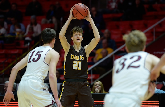 (Francisco Kjolseth  |  The Salt Lake Tribune)  Davis vs Lone Peak, 6A State high school basketball tournament at the Huntsman Center in Salt Lake City, Thursday March 1, 2018. Tyson Garff (21) looks for an opening. 
