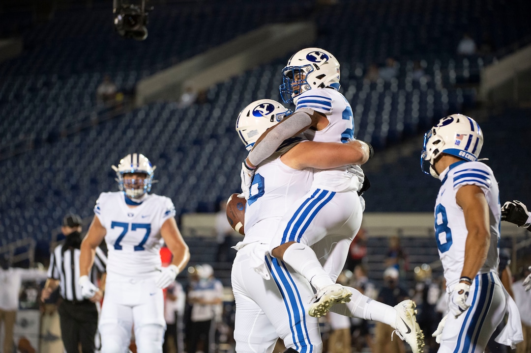 BYU's Tyler Allgeier celebrates with teammates after scoring a touchdown during the first half of an NCAA college football game against Navy, Monday, Sept. 7, 2020, in Annapolis, Md. (AP Photo/Tommy Gilligan)