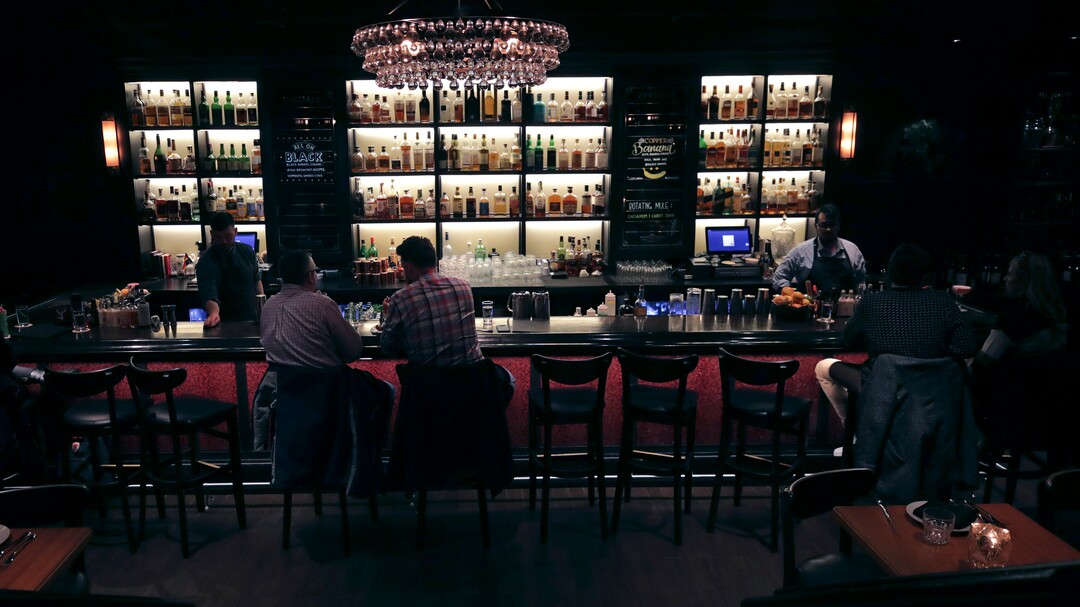 In this Dec. 10, 2019, photo patrons and mixologists at Wink & Nod, basement-dwelling, speakeasy-like bar, in Boston. Americans are consuming more alcohol per capita now than in the time leading up to Prohibition, when alcohol opponents successfully made the case that excessive drinking was ruining family life. (AP Photo/Charles Krupa)