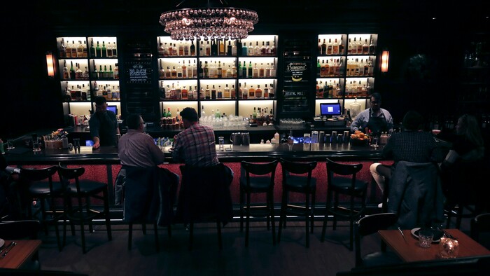 In this Dec. 10, 2019, photo patrons and mixologists at Wink & Nod, basement-dwelling, speakeasy-like bar, in Boston. Americans are consuming more alcohol per capita now than in the time leading up to Prohibition, when alcohol opponents successfully made the case that excessive drinking was ruining family life. (AP Photo/Charles Krupa)