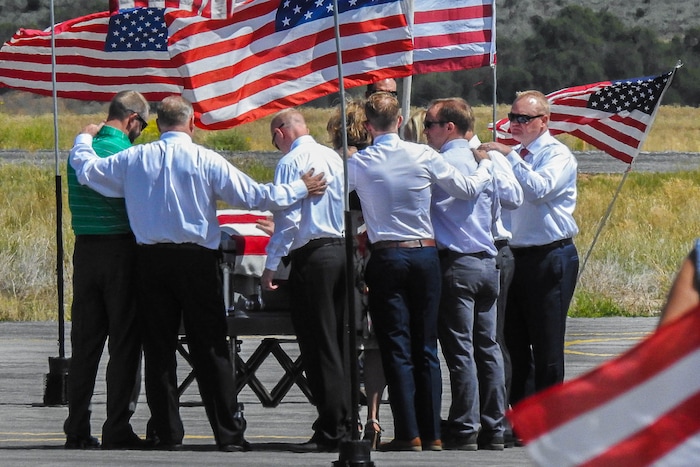 (Trent Nelson | The Salt Lake Tribune)  Family members gather around the casket of fallen soldier Aaron Butler, who was killed last week in Afghanistan, at the Monticello Airport, Thursday August 24, 2017.