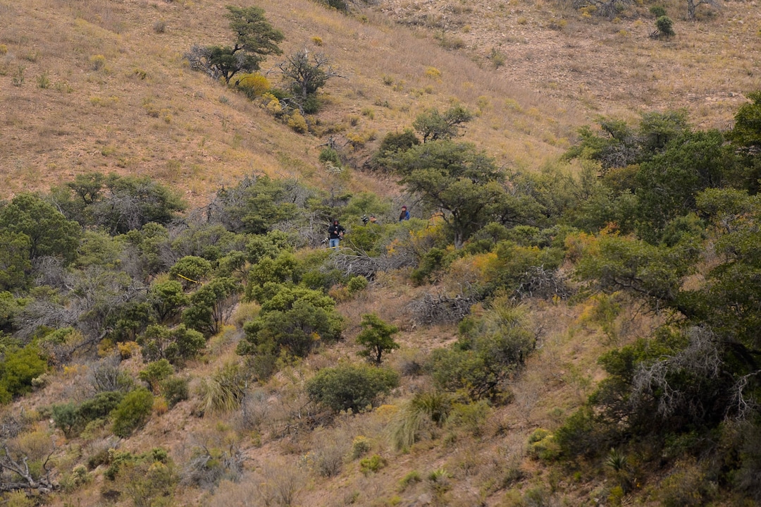 (Trent Nelson  |  The Salt Lake Tribune)Figures near killers' footprints cause a convoy to nervously halt, as they make their way through the mountains to more funerals near La Mora, Sonora on Friday Nov. 8, 2019. The men standing where gunmen shot and killed Dawna Ray Langford and Christina Marie Langford, along with two of Dawna's children (Trevor, 11, and Rogan, 3) turned out to be photographers.