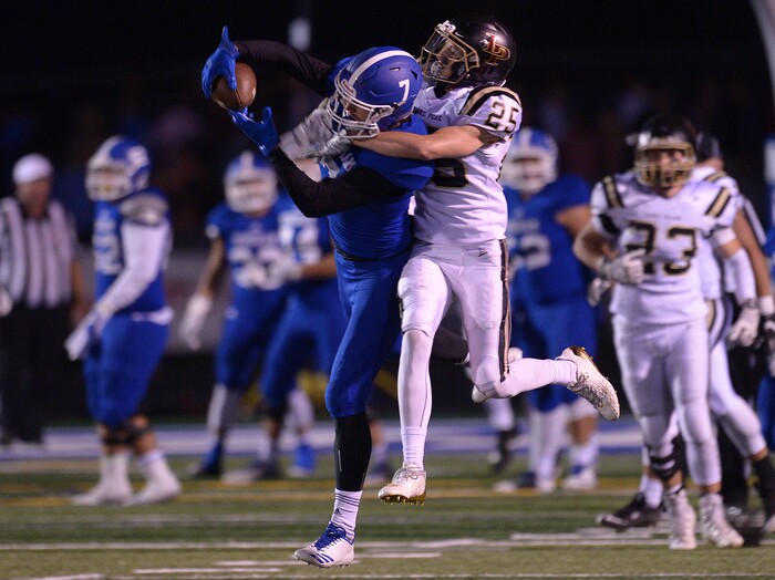 (Leah Hogsten | The Salt Lake Tribune) Bingham's Brayden Cosper pulls in the catch over Lone Peak's Brock McChesney. Bingham High School defeated Lone Peak High School, 28-10 during their game Friday, September 28, 2017 in South Jordan.