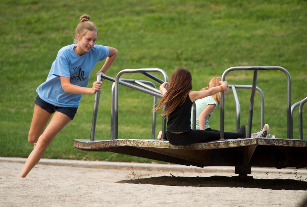(Rick Egan | The Salt Lake Tribune) Kids play on the merry-go-round at Lindsey Gardens, Sunday, July 19, 2015. There is a plan to renovate the Lindsey Gardens playground and get rid of the classic metal merry-go-round. Residents are organizing to save it. Wednesday, September 14, 2016.