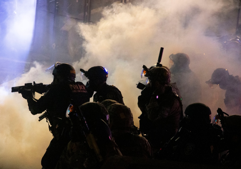 Federal officers use chemical irritants and projectiles to disperse Black Lives Matter protesters early late Thursday, July 23, 2020, in Portland, Ore. Since federal officers arrived in downtown Portland in early July, violent protests have largely been limited to a two block radius from the courthouse. (Beth Nakamura /The Oregonian via AP)