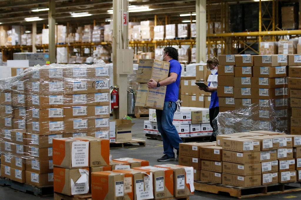 (Sue Ogrocki | AP file photo) Workers carry boxes at Oklahoma's Strategic National Stockpile warehouse in Oklahoma City on April 7, 2020. States are spending billions of dollars stocking up on medical supplies like masks and breathing machines during the coronavirus pandemic. An Associated Press survey of all 50 states found a hodgepodge of public information about the purchase of masks, gloves, gowns and other hard-to-get equipment for medical and emergency workers.