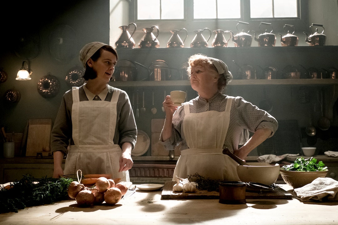 This image released by Focus Features shows Sophie McShera as Daisy Mason, left, and Lesley Nicol as Mrs. Patmore in "Downton Abbey". The film will be released Sept. 13, 2019, in the United Kingdom and on Sept. 20 in the United States. (Jaap Buitendijk/Focus Features via AP)