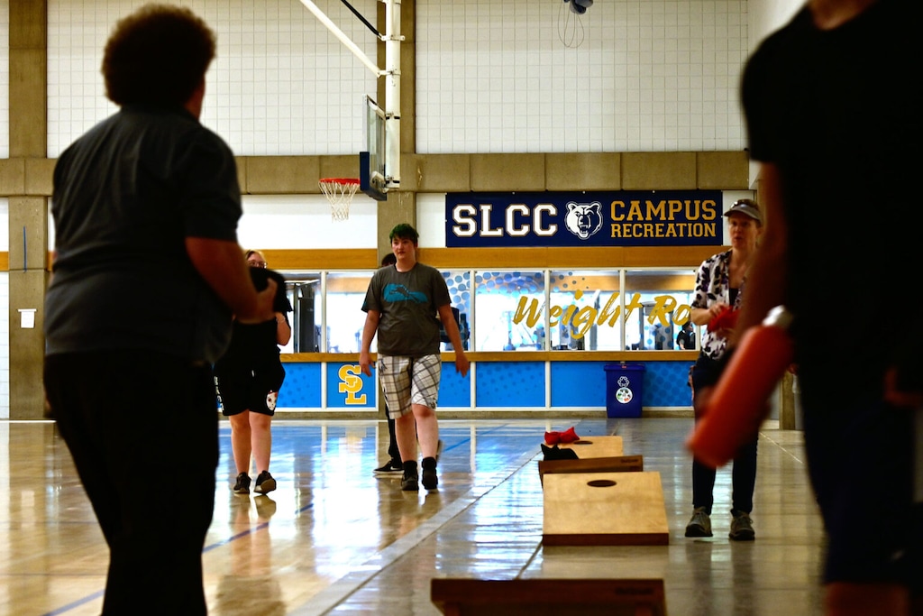 (Joseph Holder  |  The Globe at SLCC) Participants toss bean bags in the Lifetime Activities Center at Salt Lake Community College's Taylorsville Redwood campus, for the school's first Trans Sports Ball Day, on June 26, 2023. The event was designed to promote inclusion of transgender people in athletic events.