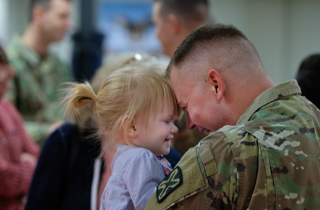 (Francisco Kjolseth  |  The Salt Lake Tribune)  Sgt. Jordan Bowden embraces his niece Navy Janis, 2, as family members attend departure ceremonies for the 141st Military Intelligence Battalion at the Utah National Guard headquarters in Draper on Monday, March 19, 2018. 