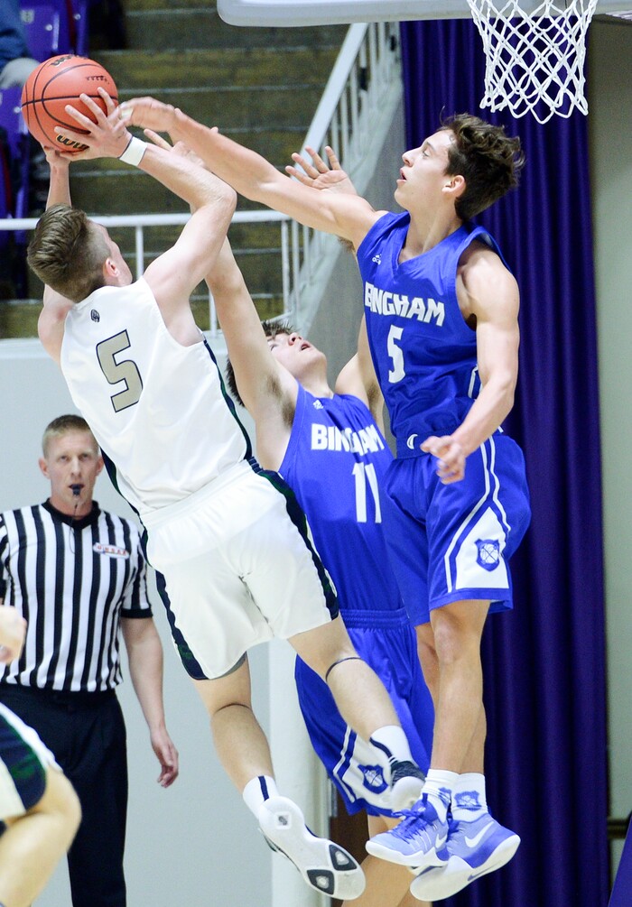 (Leah Hogsten  |  The Salt Lake Tribune) Bingham's Dax Milne (05) and Bingham's Dalton Miller (11) guard Copper Hills' Tyler Bush (05). Copper Hills faces Bingham in the 6A High School Boys' Basketball Tournament opening game at Weber State University’s Dee Events Center in Ogden, Tuesday, Feb. 27, 2018. 