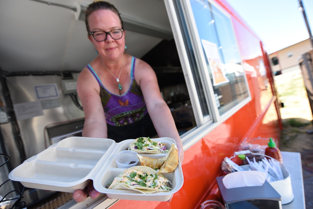(Francisco Kjolseth  |  The Salt Lake Tribune)  Co-owner Amy Dunyon serves an order of Tokyo tacos from the Umai food truck.