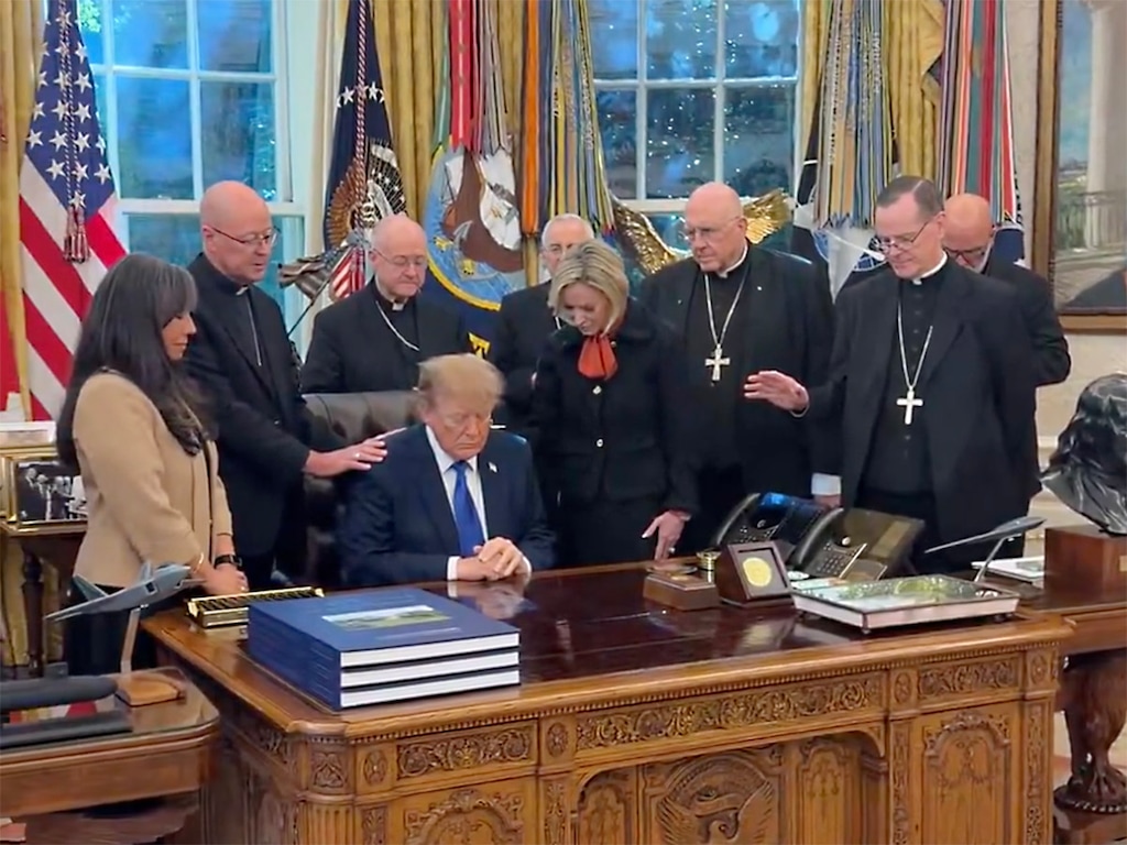 (Video screen grab via RNS) Catholic bishops, with Jenny Korn, left, and Paul White-Cain, center, pray over President Donald Trump in the Oval Office on Thursday, Oct. 22, 2026.