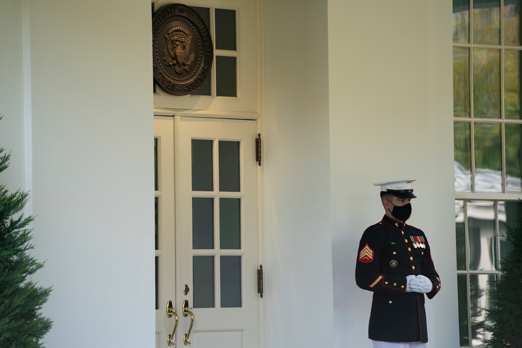 A Marine is posted outside the West Wing of the White House, signifying the President is in the Oval Office, Friday, Oct. 9, 2020, in Washington. (AP Photo/Evan Vucci)