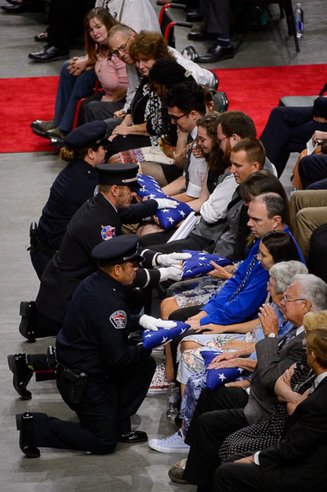 (Trent Nelson | The Salt Lake Tribune)  West Valley City police officers perform a flag presentation for family members at funeral services for Jill Robinson, a West Valley City code-enforcement officer killed on the job last week. The service took place at the Maverik Center in West Valley City on Friday Aug. 17, 2018.