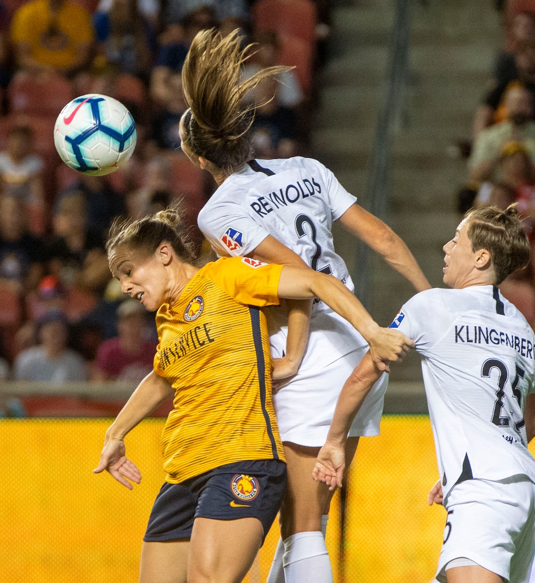 (Rick Egan  |  The Salt Lake Tribune)    Utah Royals FC forward Amy Rodriguez (8) goes for the ball as Portland Thorns FC defender Katherine Reynolds (2) and Portland Thorns FC defender Meghan Klingenberg (25), in Soccer action between Utah Royals FC and Portland Thorns FC, in Sandy, Friday, July 19, 2019.