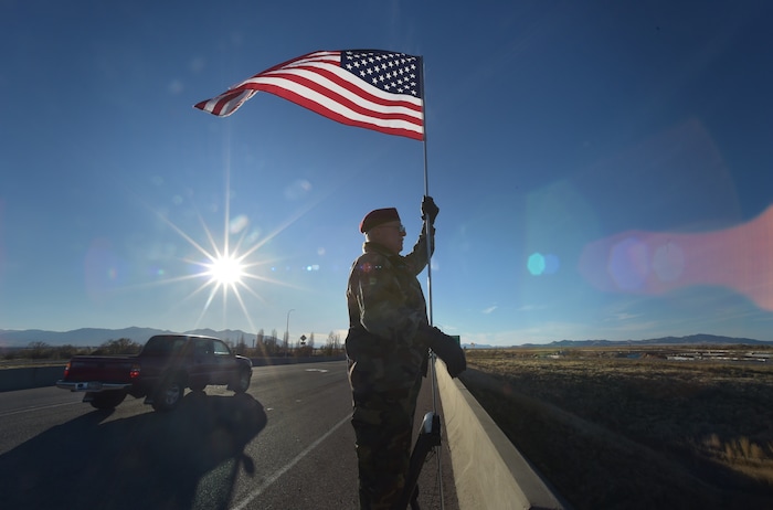 (Scott Sommerdorf   |  The Salt Lake Tribune)   Veteran Bob Fillmore salutes motorists passing beneath him as he stands on the 2100 North overpass over I-215, Saturday, November 11, 2017. Fillmore, who served in Germany, says he began his day on the overpass at 6am, and intended to stay there till dark to mark Veteran's Day.