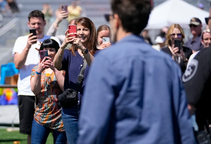 (Bethany Baker | The Salt Lake Tribune) People take photos of Kevin Bacon during a charity event to commemorate the 40th anniversary of the movie "Footloose" on the football field of Payson High School in Payson on Saturday, April 20, 2024.