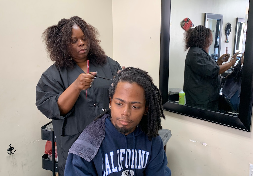 (AP Photo/Terry Chea)
Charlotte "Peaches" Smith, owner of the Dreadlocks Salon, works on a customer's dreadlocks Wednesday, July 3, 2019, in Oakland, Calif. California has become the first state to ban workplace and school discrimination against black people for wearing hairstyles such as braids, twists and locks.