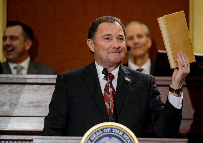 (Steve Griffin  |  The Salt Lake Tribune) Gov. Gary Herbert holds up a book of laws passed by the 1918 Utah Sate Legislature as he gives his State of the State address in the Utah House of Representatives in Salt Lake City Wednesday January 24, 2018.