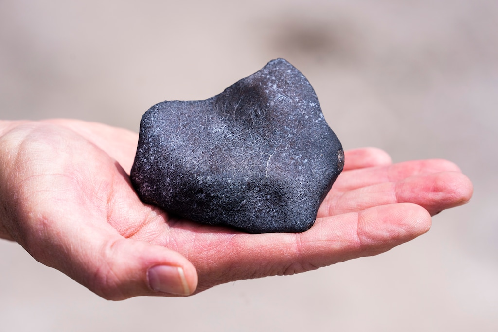 (Rick Egan | The Salt Lake Tribune) A meteorite found by Mark Dayton, in the desert near Tooele, shown on Wednesday, Aug. 24, 2022. It's around the size of a softball and likely broke off from the meteor above Salt Lake City on Aug. 13, 2022.