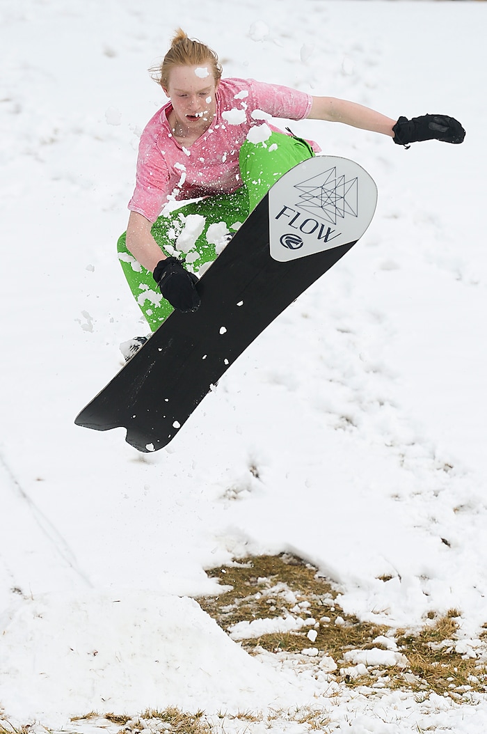 (Leah Hogsten  |  The Salt Lake Tribune)  Kolten Meiners, 14, catches air off a make-shift snow ramp Sunday, March 4, 2018 while perfecting his snowboarding skills in his Ogden neighborhood. 