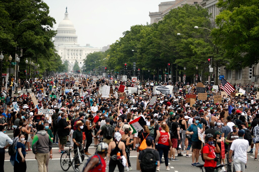 (Andrew Harnik | AP file photo)  Demonstrators walk on Pennsylvania Avenue as they protest, Saturday, June 6, 2020, in Washington, over the death of George Floyd, a black man who was in police custody in Minneapolis. Floyd died after being restrained by Minneapolis police officers.