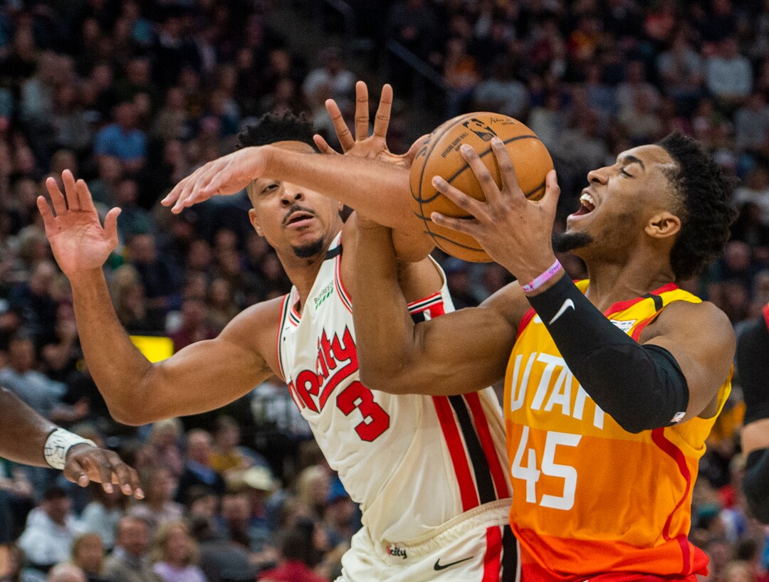(Rick Egan  |  The Salt Lake Tribune)     Utah Jazz guard Donovan Mitchell (45) takes the ball to the hoop, as Portland Trail Blazers guard CJ McCollum (3) defends, in NBA action between the Utah Jazz and thePortland Trail Blazers in Salt Lake City, Friday, Feb. 7, 2020.