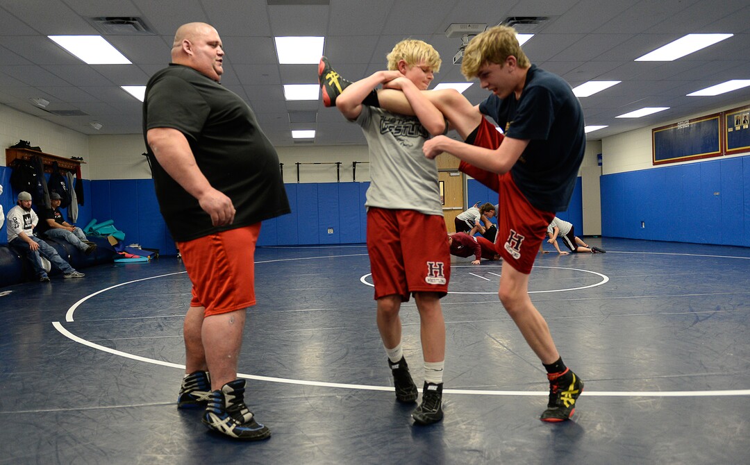(Francisco Kjolseth  |  The Salt Lake Tribune)  Olympic wrestling champion Rulon Gardner runs an introductory clinic with young wrestlers Oscar Madison, 15, center, and William Mangum, 16, at Herriman High School after being introduced as the new coach on Wed. May 17, 2018.