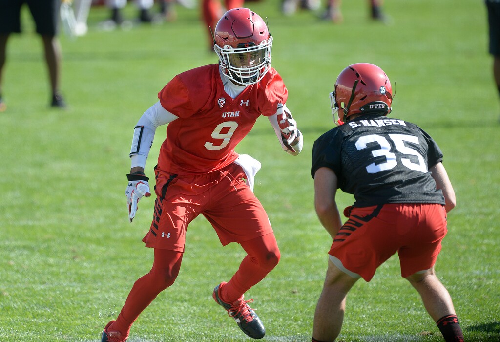 Scott Sommerdorf   |  The Salt Lake Tribune  
Darren Carrington II jukes defensive back Shawn Hansen during the first day of Utah fall football camp.