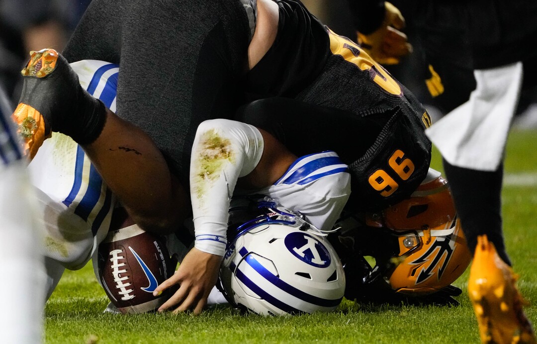 (Francisco Kjolseth | The Salt Lake Tribune) Brigham Young Cougars quarterback Jaren Hall (3) is turned into a pretzel by the Arizona State Sun Devils in the final minutes of play at LaVell Edwards Stadium in Provo, on Saturday, Sept. 18, 2021.