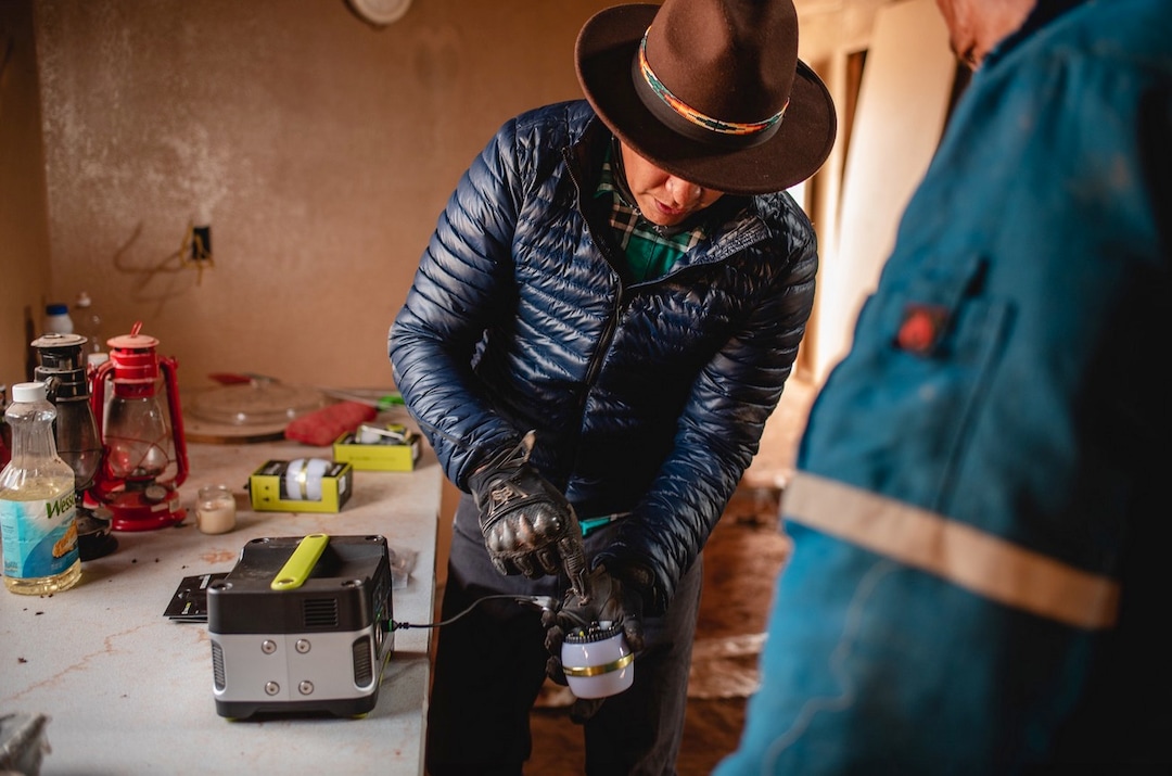 (Courtesy of Laura Dearden | Real Salt Lake Foundation) Mylo Fowler sets up a solar-powered LED light in San Juan County in November 2019.