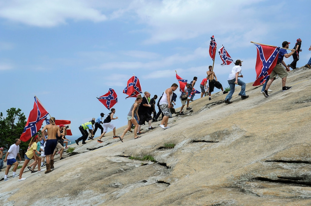 (AP Photo/John Amis, File)

In this Aug. 1, 2015, photo, supporters carrying Confederate battle flags climb Stone Mountain to protest what they believe is an attack on their Southern heritage during a rally in Stone Mountain, Ga.