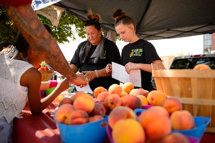 (Trent Nelson | The Salt Lake Tribune)  April and Brittney Nelson of Nelson Farms at the Tuesday Farmer's Market in Salt Lake City's Pioneer Park, Tuesday Aug. 14, 2018. The laid-back market continues now through September and features about 20 vendors.