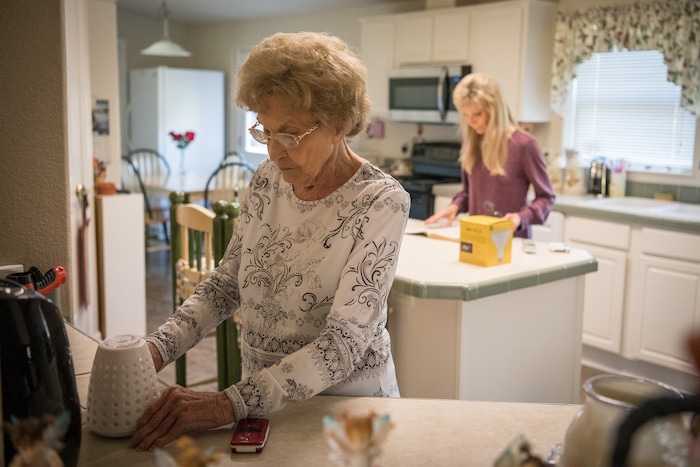(Loren Elliott  |  For The Washington Post)  Dorothy O'Connell organizes her kitchen with her daughter, Elaine Dilley, who said her mother's pain was so intense "you couldn't touch her."