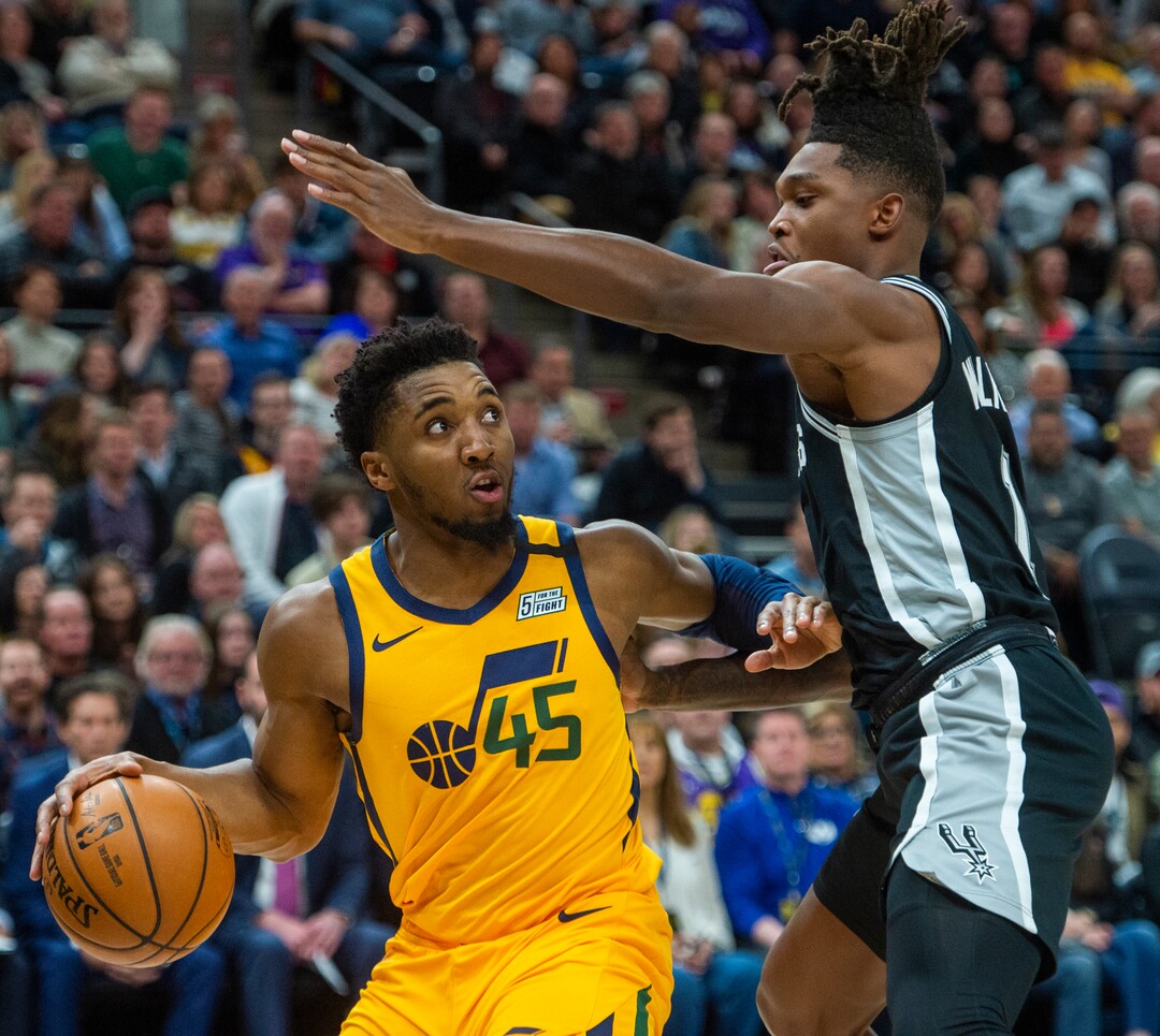 (Rick Egan  |  The Salt Lake Tribune)    Utah guard Donovan Mitchell (45)looks for a shot as San Antonio Spurs guard Lonnie Walker IV (1) defends, in NBA action between the Utah Jazz and the San Antonio Spurs, in Salt Lake City, Friday, Feb. 21, 2020.