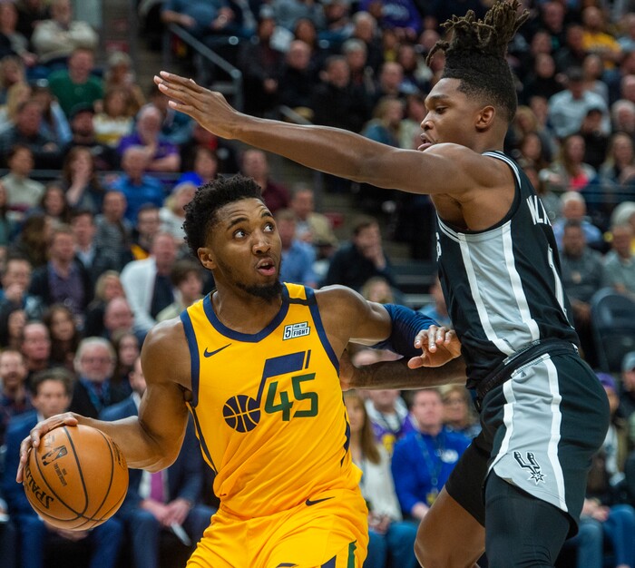 (Rick Egan  |  The Salt Lake Tribune)    
Utah guard Donovan Mitchell (45)looks for a shot as San Antonio Spurs guard Lonnie Walker IV (1) defends, in NBA action between the Utah Jazz and the San Antonio Spurs, in Salt Lake City, Friday, Feb. 21, 2020.