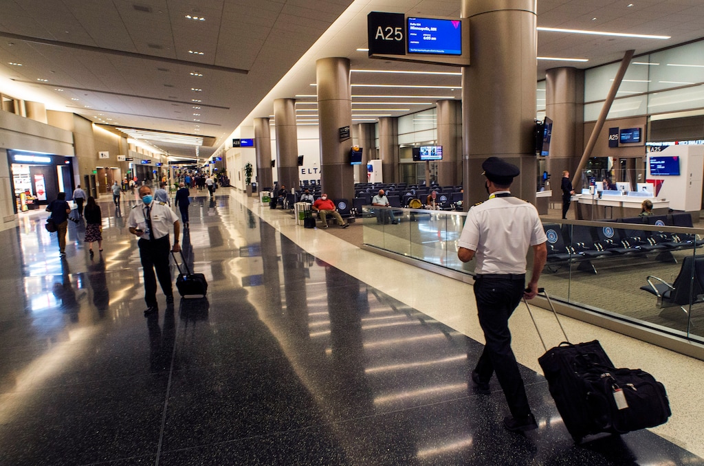 (Rick Egan | Tribune file photo) Passengers and employees walk down the new terminal at the Salt Lake City International Airport on Sept. 15, 2020.