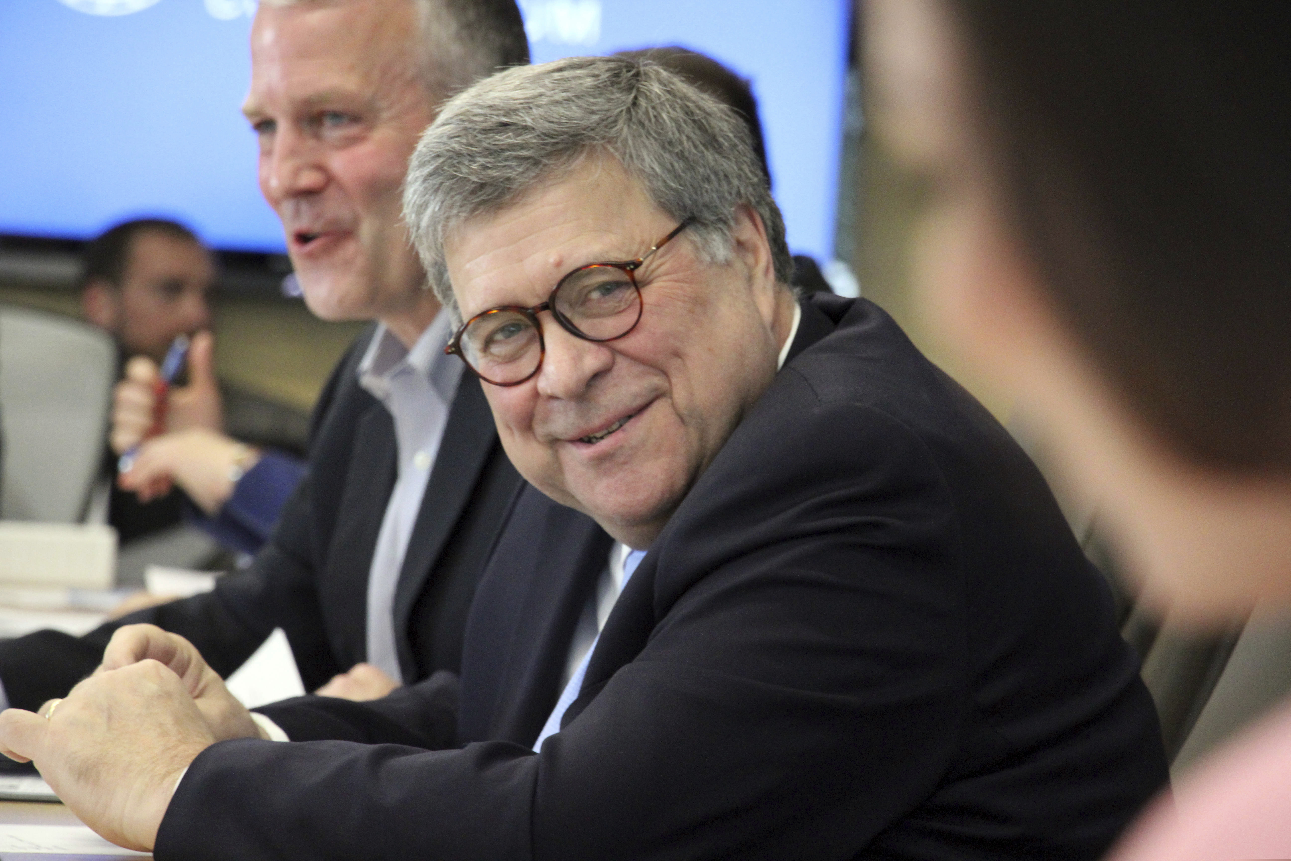 U.S. Attorney General William Barr, middle, smiles during a light moment when listening to concerns raised about public safety in rural Alaska during at a roundtable discussion at the Alaska Native Tribal Health Consortium on Wednesday, May 29, 2019, in Anchorage, Alaska. Barr did not take questions from reporters in his first public appearance after former special prosecutor Robert Mueller spoke to reporters after resigning at the completion of his report into Russian interference into the 2016 election. (AP Photo/Mark Thiessen)