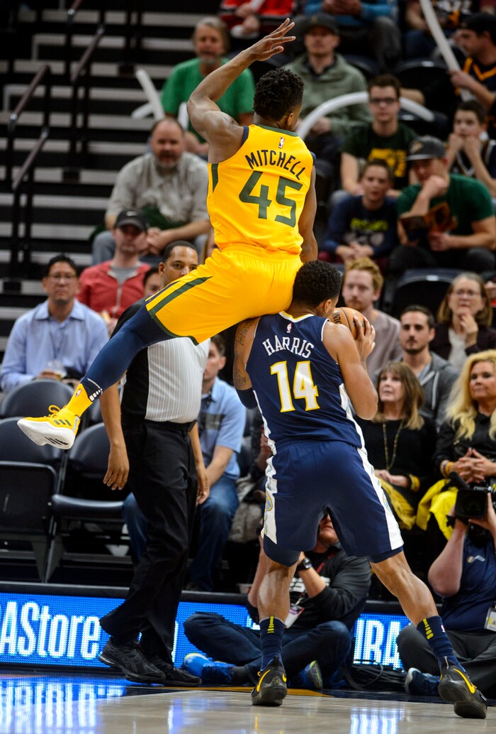(Steve Griffin  |  The Salt Lake Tribune) Utah Jazz guard Donovan Mitchell (45) lands on the shoulders of Denver Nuggets guard Gary Harris (14) during the Utah Jazz versus Denver Nuggets NBA basketball game at Vivint Smart Home Arena  in Salt Lake City Tuesday November 28, 2017.