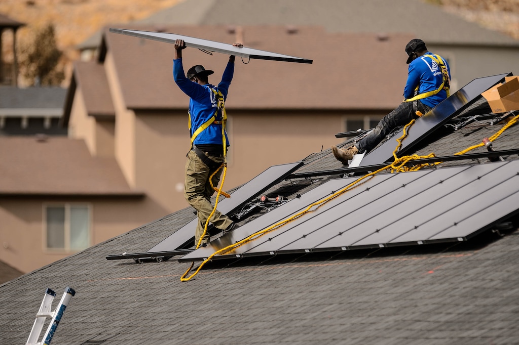 (Trent Nelson  |  The Salt Lake Tribune) LJ Jenkins and RB Biel, workers with Elan Solar, install solar panels on a Santaquin home on Friday, Nov. 6, 2020.