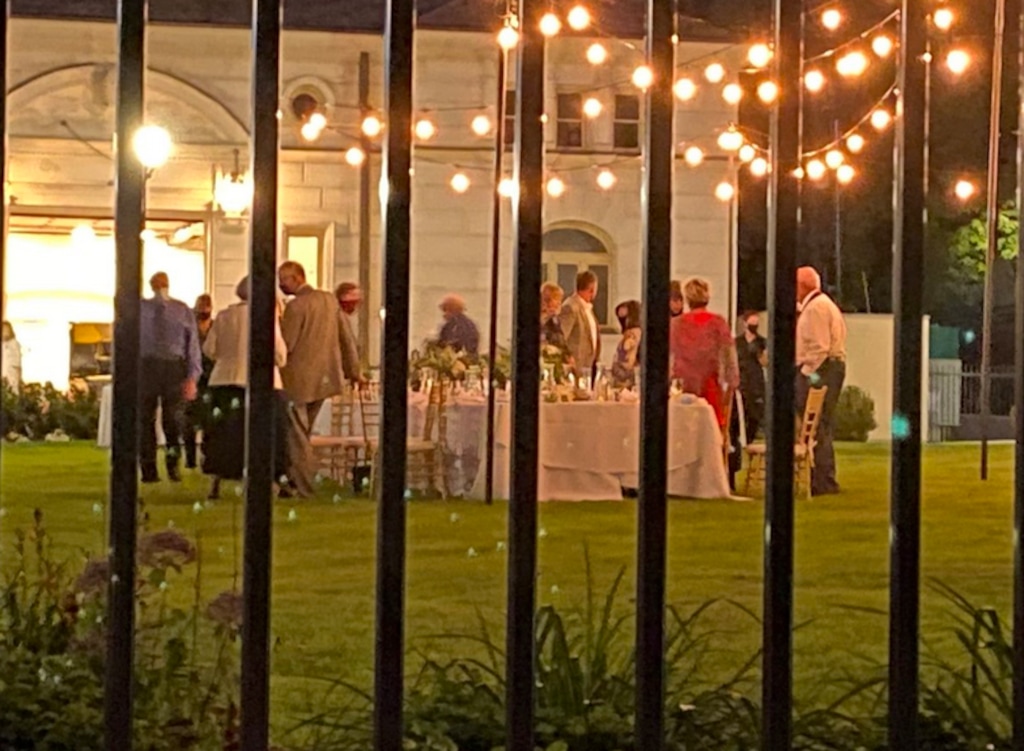 (Nicholas Rupp | Twitter post) This is a cellphone photo taken through the fence of the Utah governor's mansion, Wednesday, July 22. Salt Lake County Health Department spokesman Nicholas Rupp posted it while he was off duty. His tweet, since locked, said “Party outside tonight at the governor’s mansion in downtown #SLC, which is still in the ‘orange’ risk level,” Rupp captioned the photo. “Probably about half the visible attendees wearing a face covering. Way to walk the walk, @GovHerbert.”