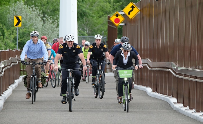 (Francisco Kjolseth | The Salt Lake Tribune) Salt Lake City Mayor Jackie Biskupski is joined by Police Chief Mike Brown, members of the public and city employees on Thursday, May 16, 2019, as part of the annual MayorÕs Bike to Work Day. This yearÕs ride began at the Northwest Recreation Center and ran primarily along the Jordan River Trail in an effort to show off the investments the city and others have made to the trail including the new 120-foot arch bridge that connects the north and south sides of the trail between 200 South and North Temple.