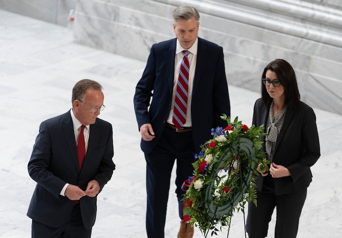 (Francisco Kjolseth | The Salt Lake Tribune) Utah Senate President Stuart Adams, state treasurer Marlo Oaks and Lt. Gov. Deidre Henderson place a wreath alongside the casket carrying former U.S. Sen. Orrin Hatch during a public viewing at the Utah Capitol on Wednesday, May 4, 2022.