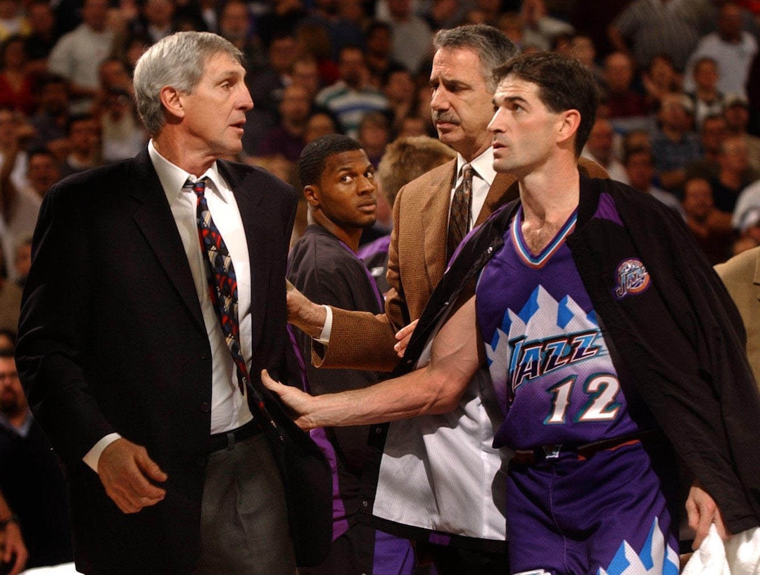 (Hector Amezcua  |  AP Photo/The Sacramento Bee) Jerry Sloan, left, is escorted off the court by assistant coach Phil Johnson and John Stockton, right, after he was ejected from a game in Sacramento in 2003.