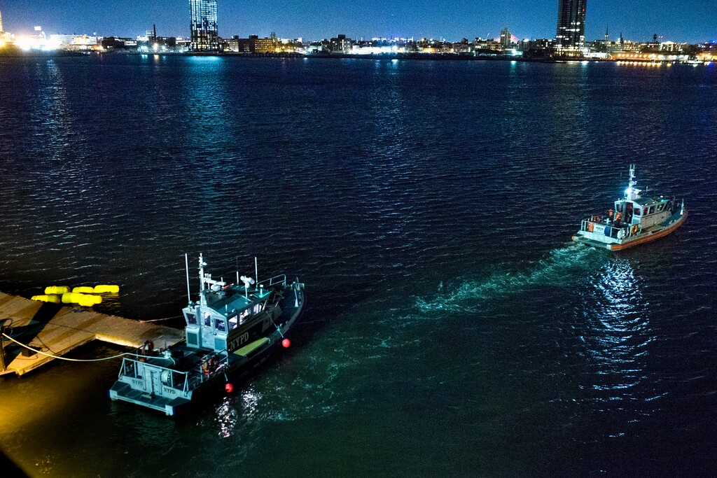 (Andres Kudacki | The Associated Press)Yellow buoys that a New York police officer said are suspending a helicopter that crashed into the East River float next to a NYPD police boat at a pier in New York on Sunday, March 11, 2018. The helicopter crashed into New York City's East River Sunday night and flipped upside down in the water, killing at least a few people aboard and leaving some others in critical condition, officials said.
