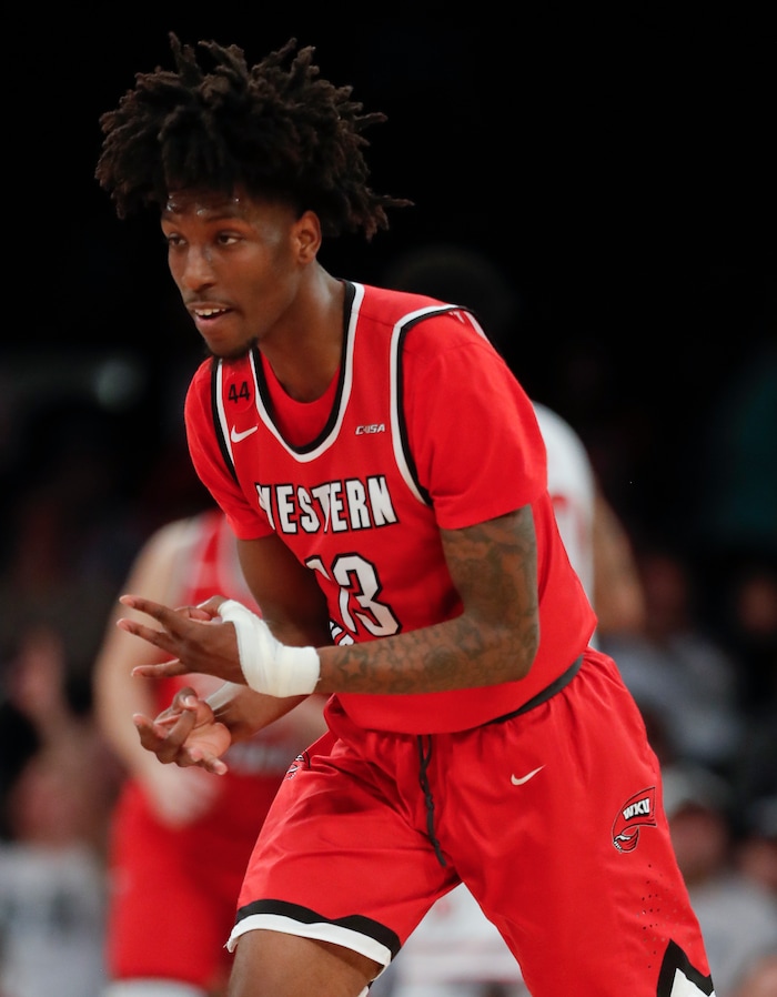 Western Kentucky guard Taveion Hollingsworth reacts after hitting a 3-point shot against Utah during the first half of an NCAA college basketball game in the semifinals of the NIT, Tuesday, March 27, 2018, in New York. (AP Photo/Julie Jacobson)