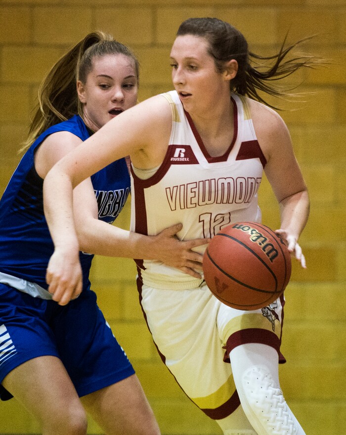 (Rick Egan  |  The Salt Lake Tribune)    Mercedes Staples (12), makes a move to the basket, as Maggie McCord (15) defends, in prep basketball action, Bingham vs. Viewmont, in Bountiful, Wednesday, January 3, 2018.