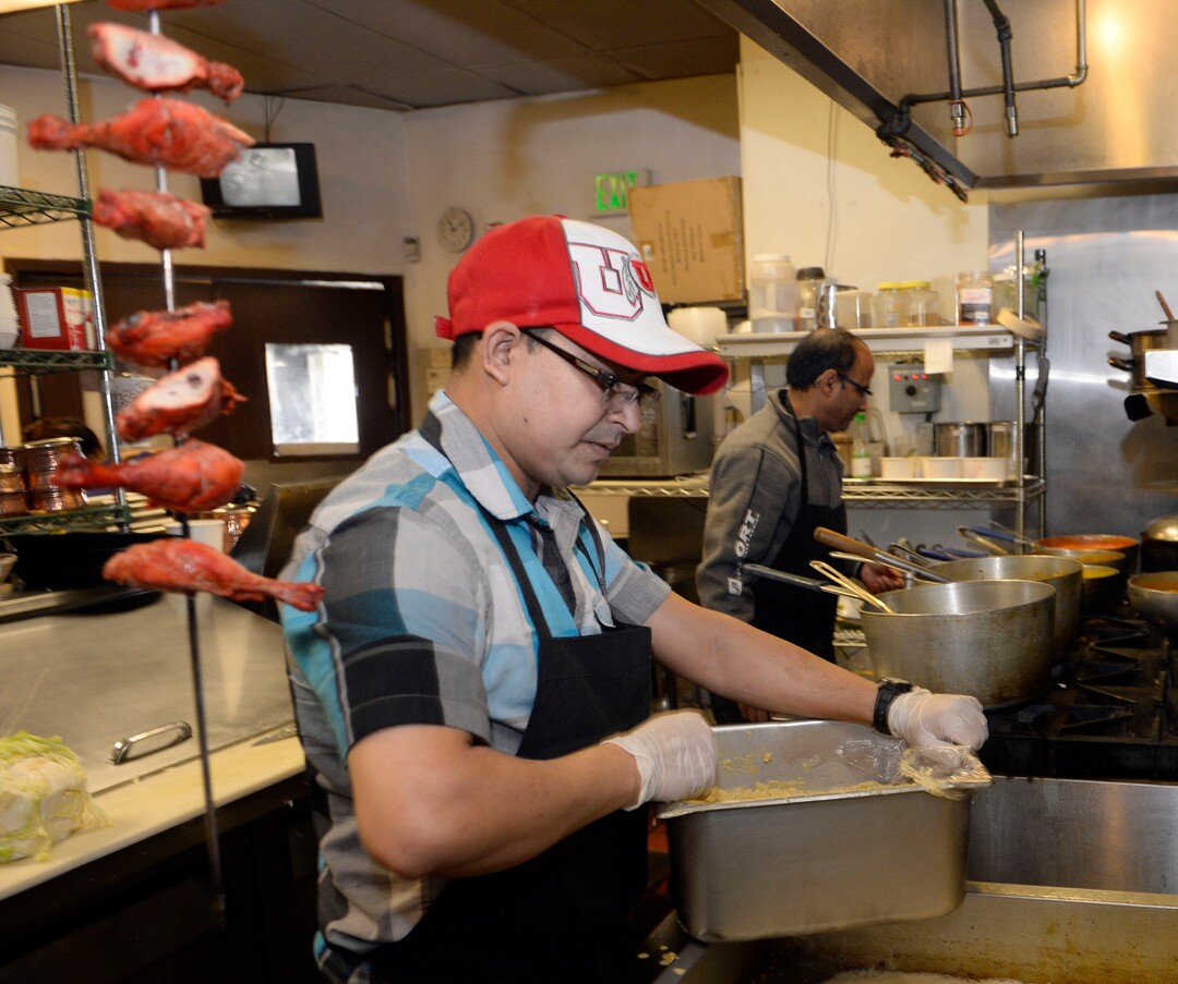 (Al Hartmann  |  The Salt Lake Tribune) 	Chef Binod Lohomi, left, and Kamal Niroula work to roll out many dishes for the lunch buffet at Bhutan House in Sandy. 