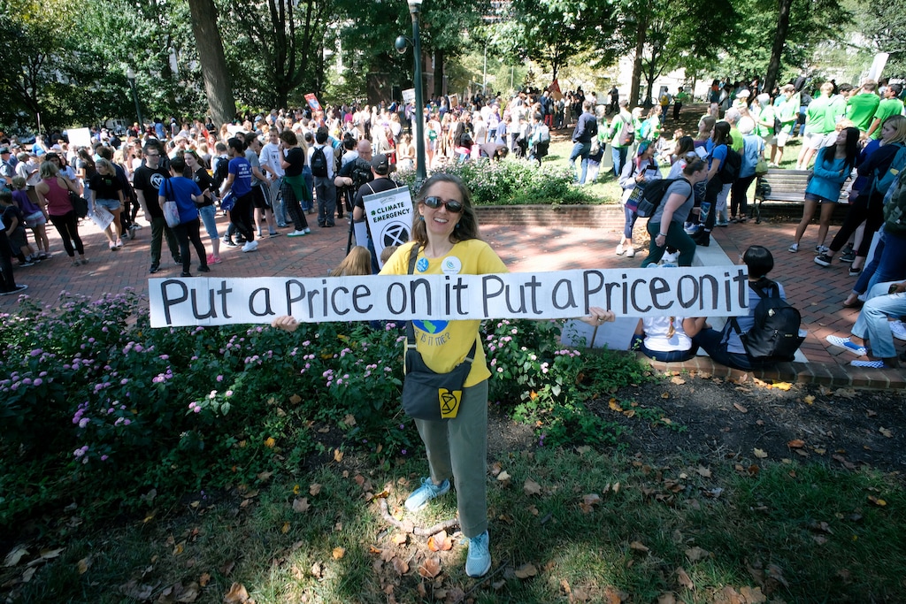(Bob Brown | Richmond Times-Dispatch via AP file) Monica Lewis with the Citizens Climate Lobby, holds a sign during a climate strike at the Bell Tower in Capitol Square in Richmond, Va., Friday, Sept. 20, 2019.